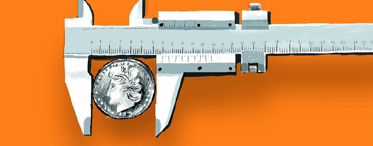 A tool measures the size of a quarter.