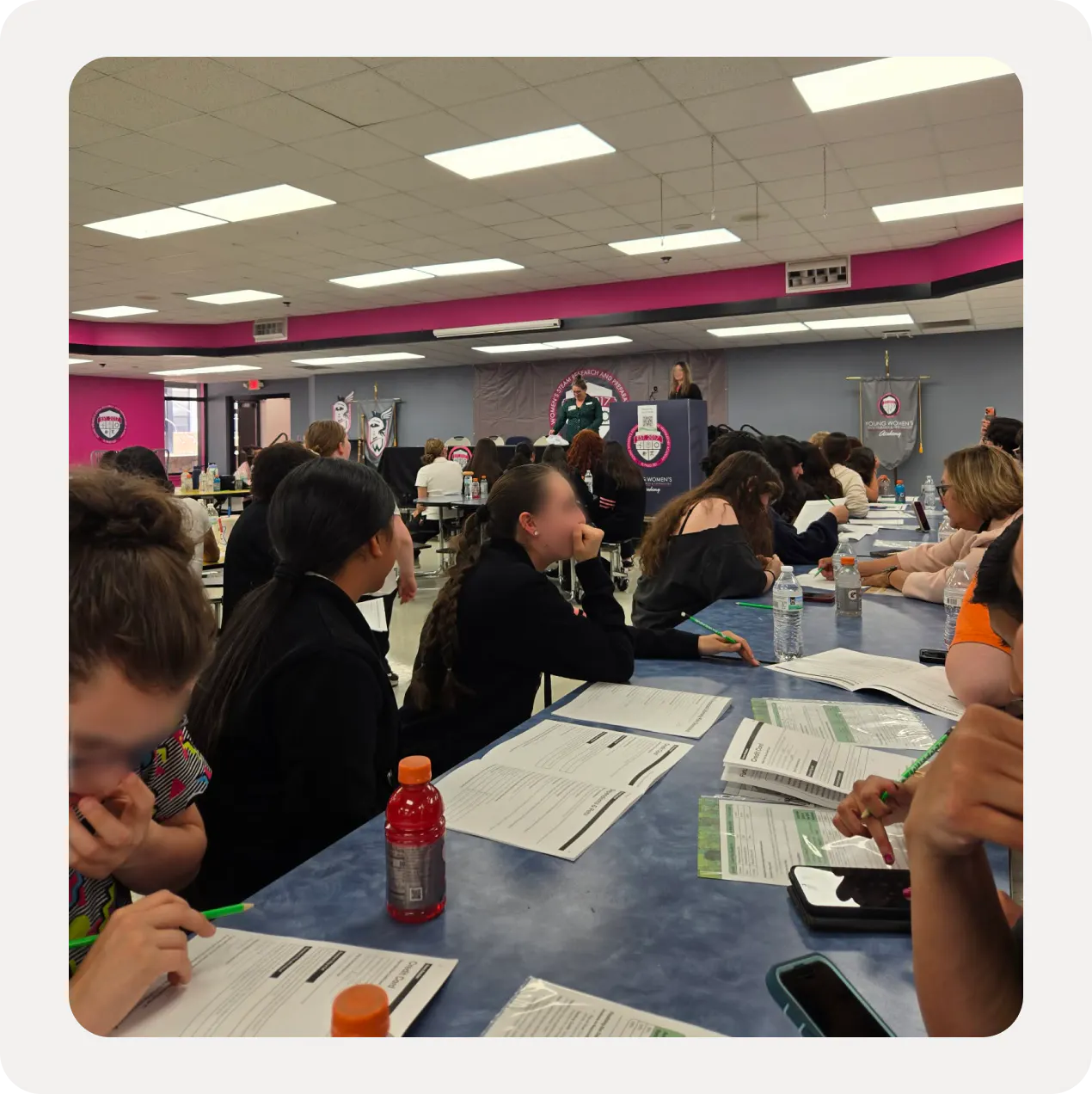 A cafeteria full of students working through Reality Fair workbooks during the fair.